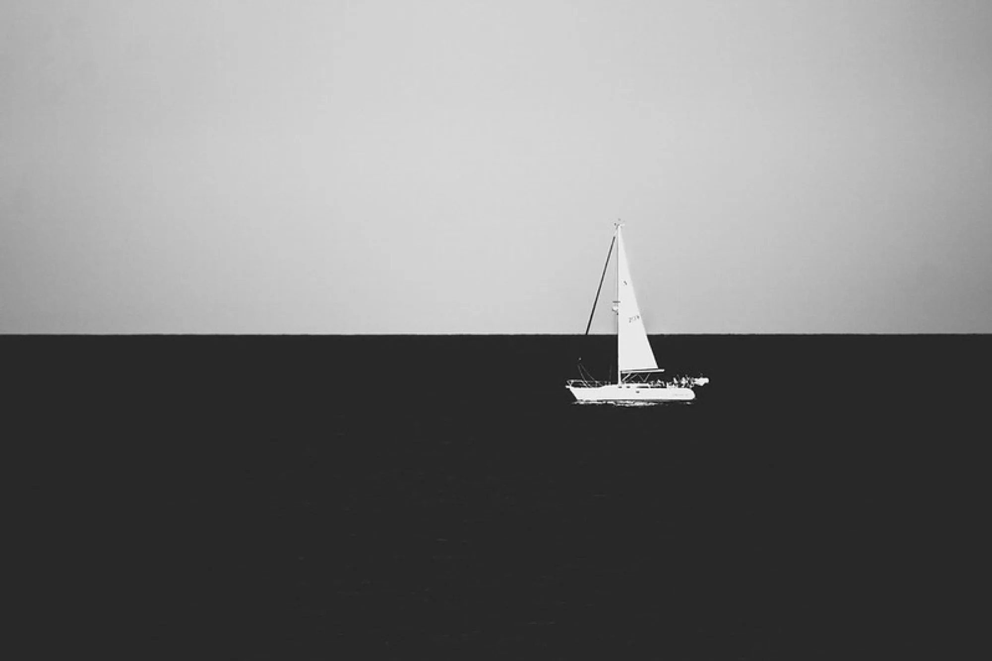 A lone sail, in black and white. Misc photography by Robin Mehdee, South Florida.